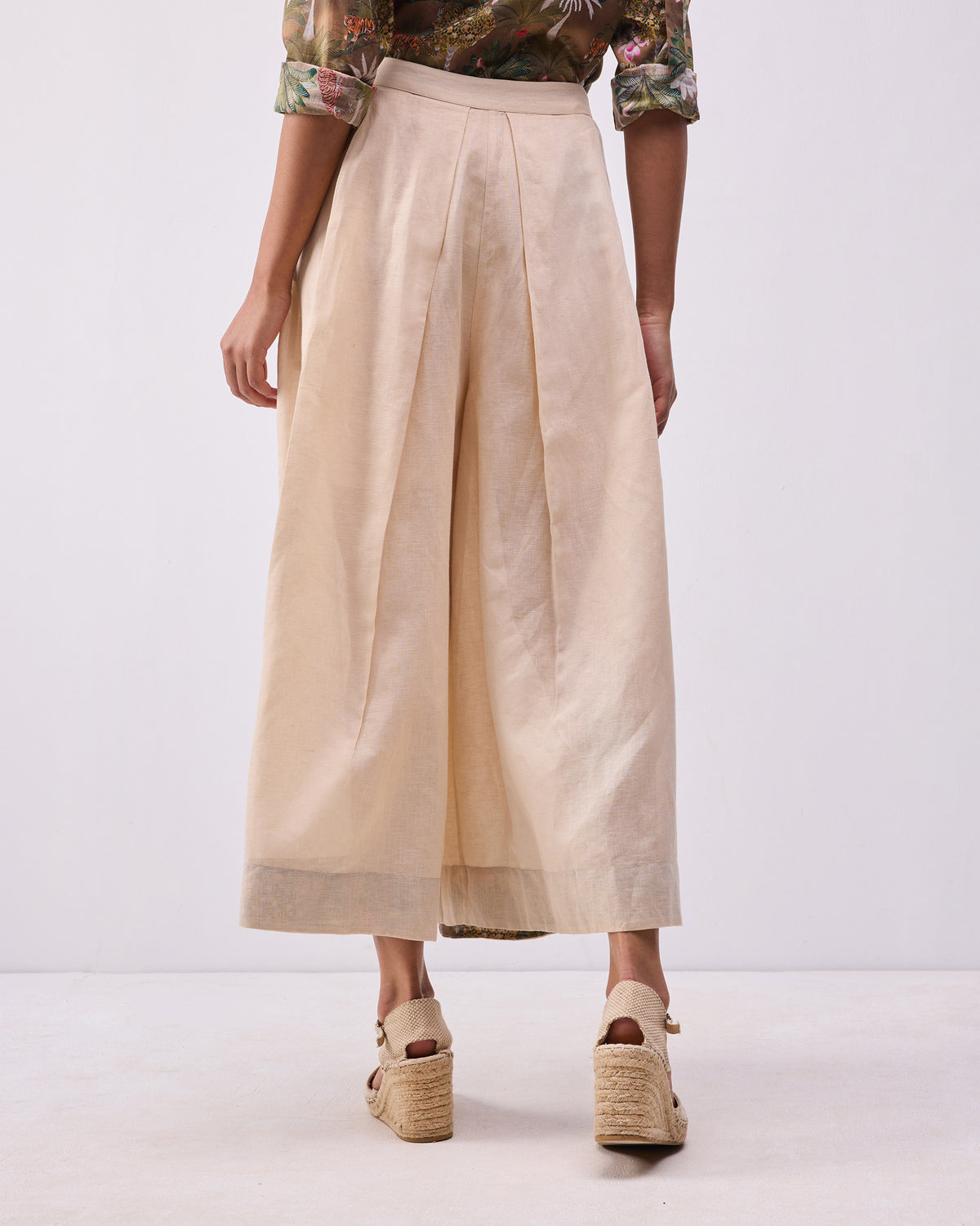 Back of a beige Pocket skort with deep inverted pleats.