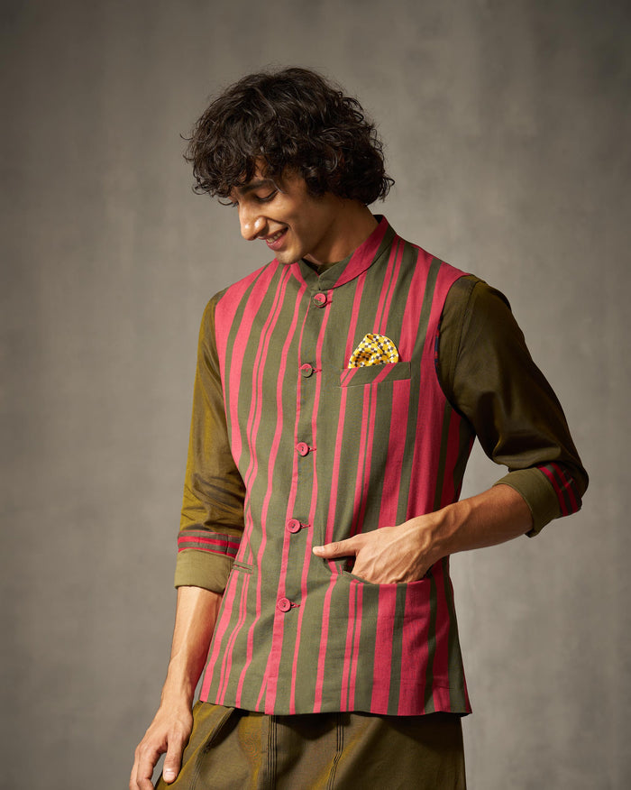 Person wearing a red and oak brown striped Nehru jacket with patch pockets.