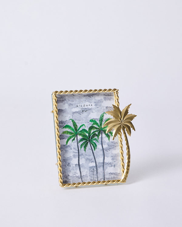 The frame front on, a print of green palms inside