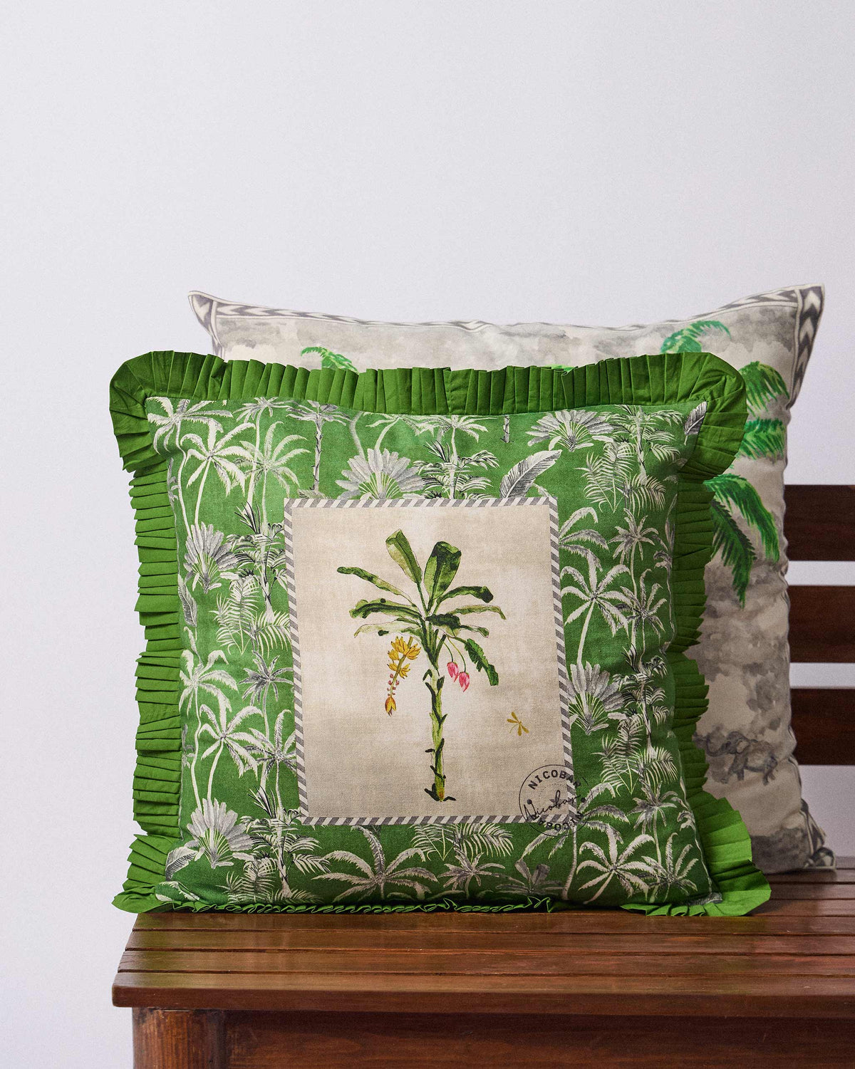 Palm Trail cushion cover with green palm print and a ruffled edge.