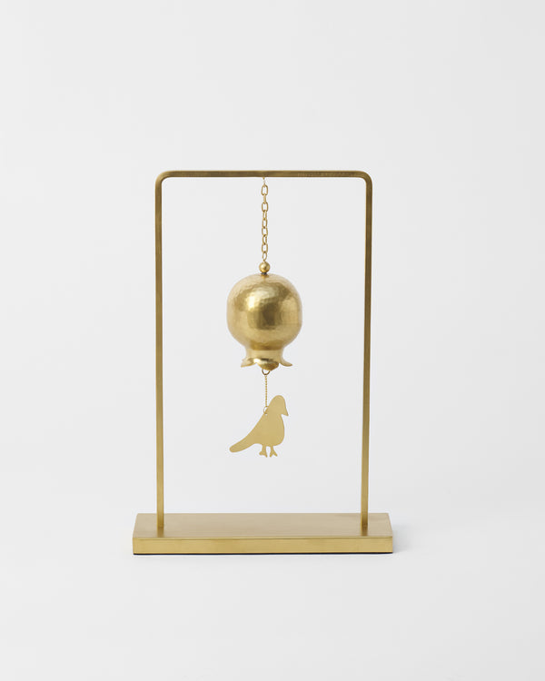 The chime hanging, bell above and bird below