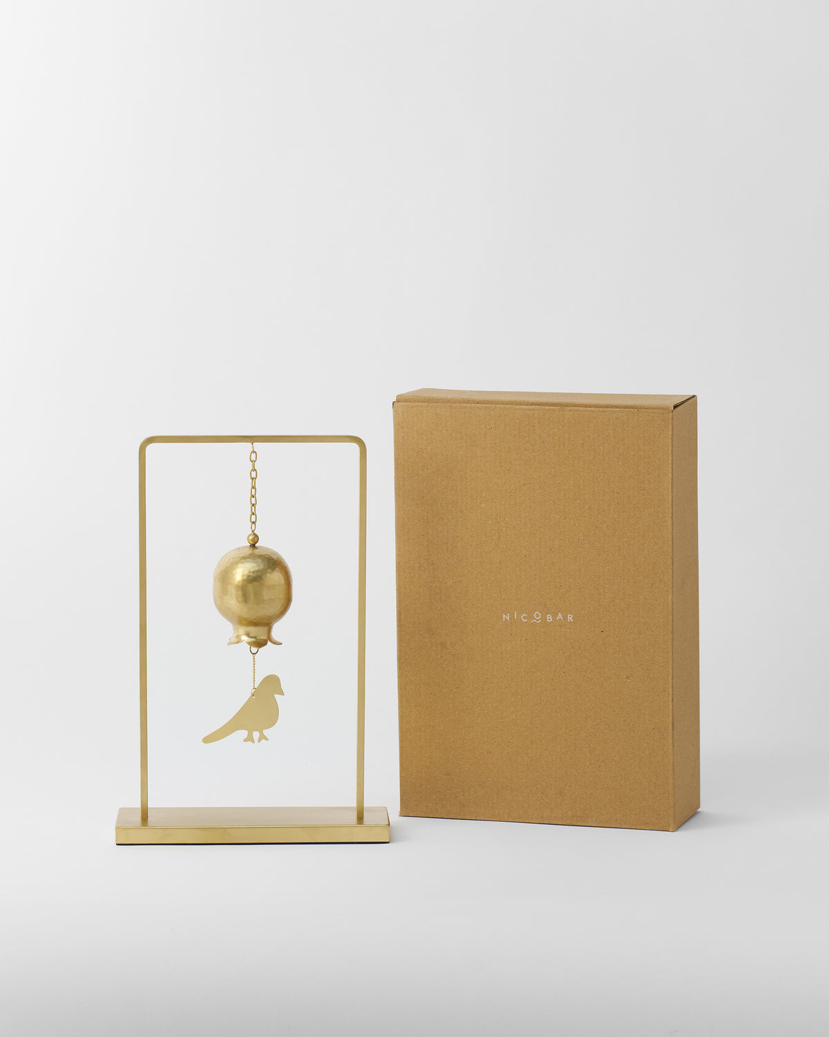 Spring Wind Chime beside its brown Nicobar gift box.