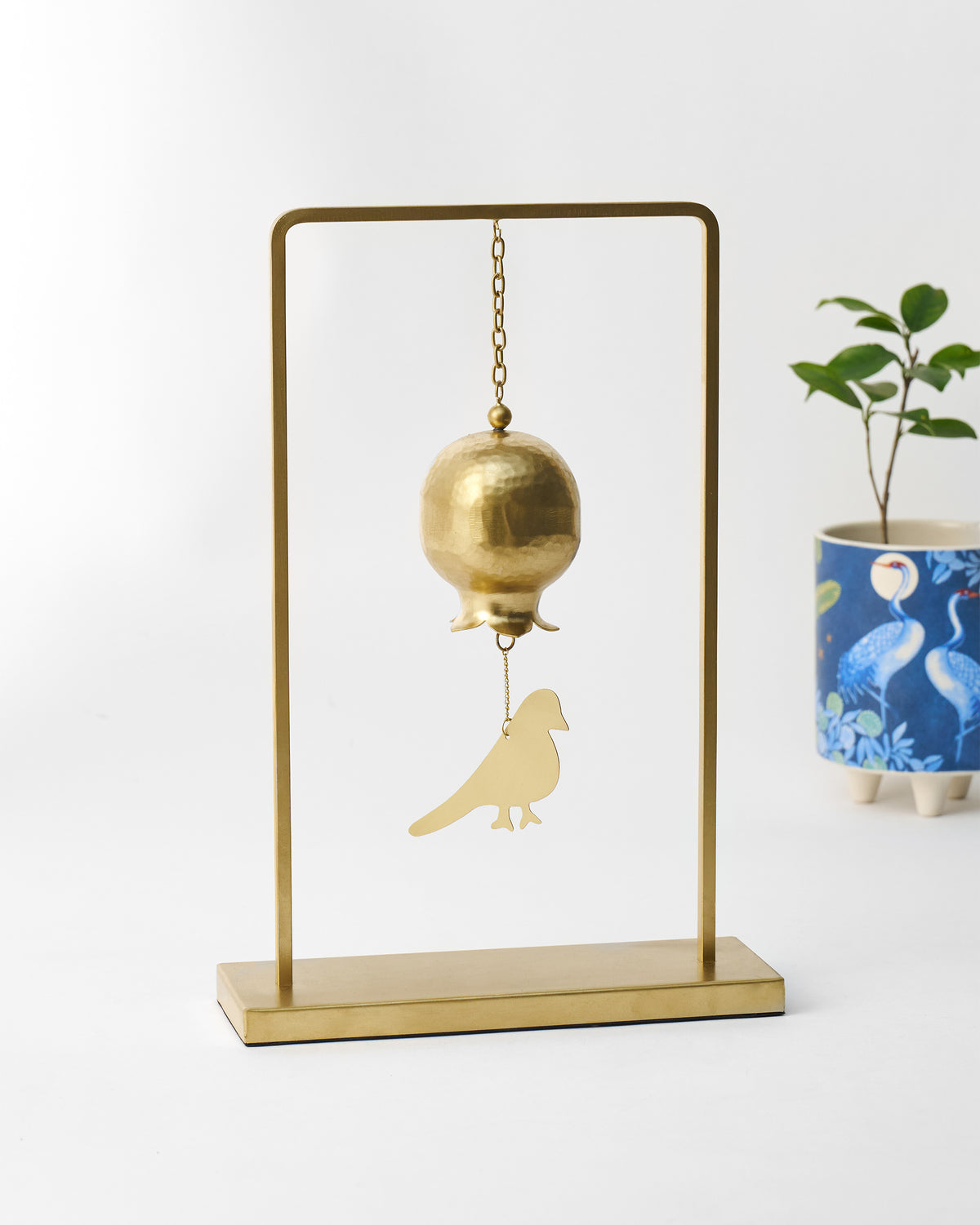 Spring Wind Chime at an angle, showing its brass bell and bird charm.
