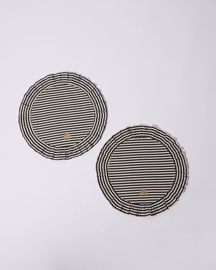 Pair of Candy Stripes placemats with ruffles and gold elephant marks.