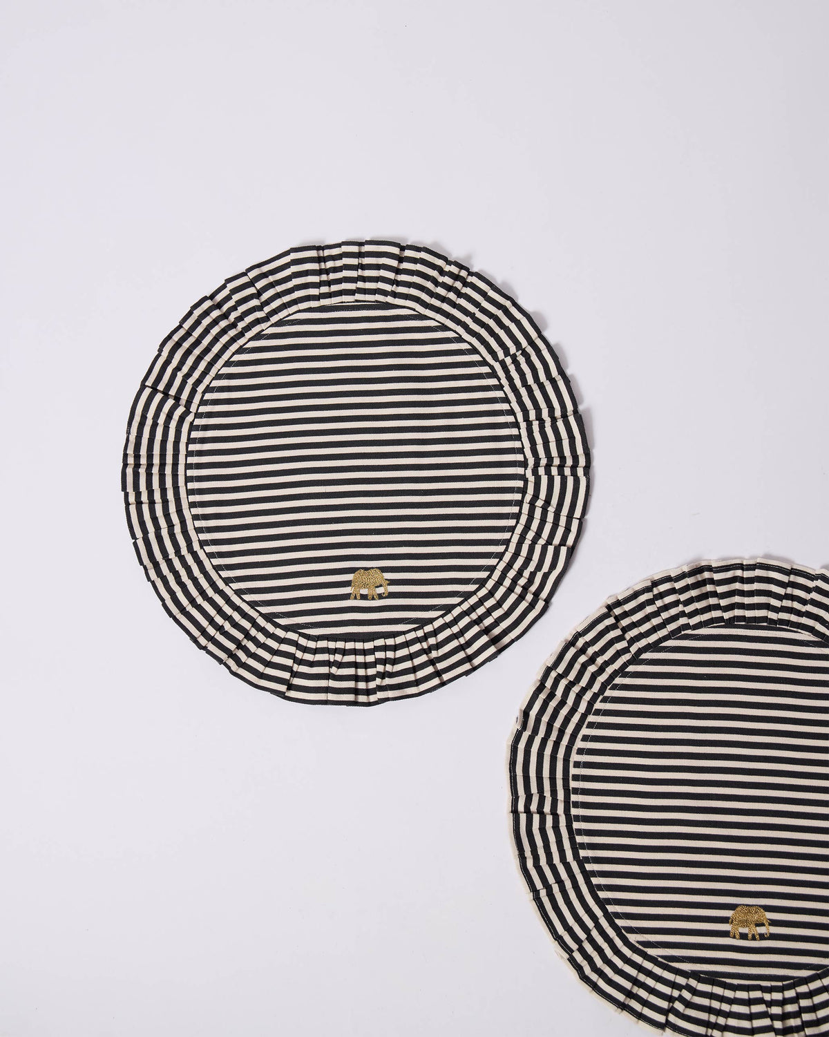 Candy Stripes placemats with pleated borders and gold elephants.