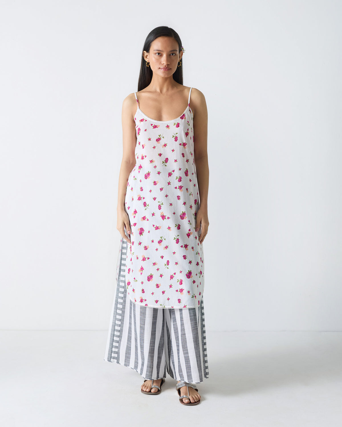 Person wearing a white Vintage Camisole with a fuchsia rose print.
