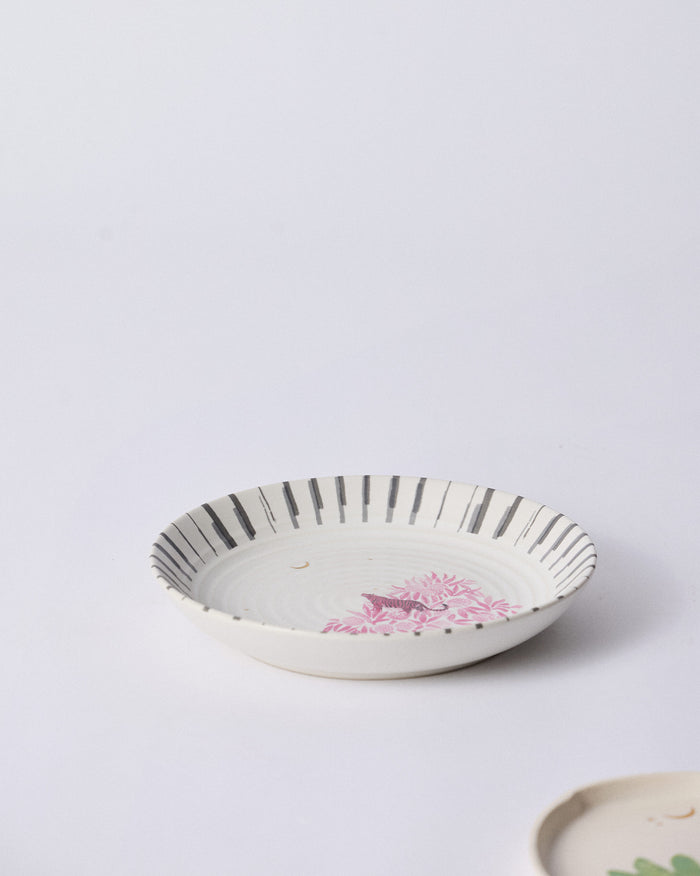 Ceylon Trail Pasta Plate with pink foliage on a striped rim.