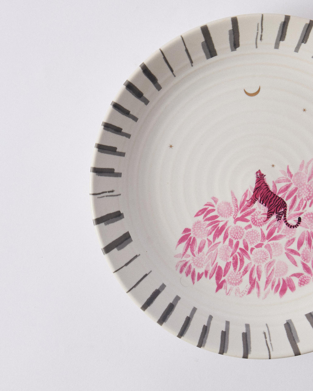 Close-up of Ceylon Trail Pasta Plate showing a pink tiger among pink flowers.