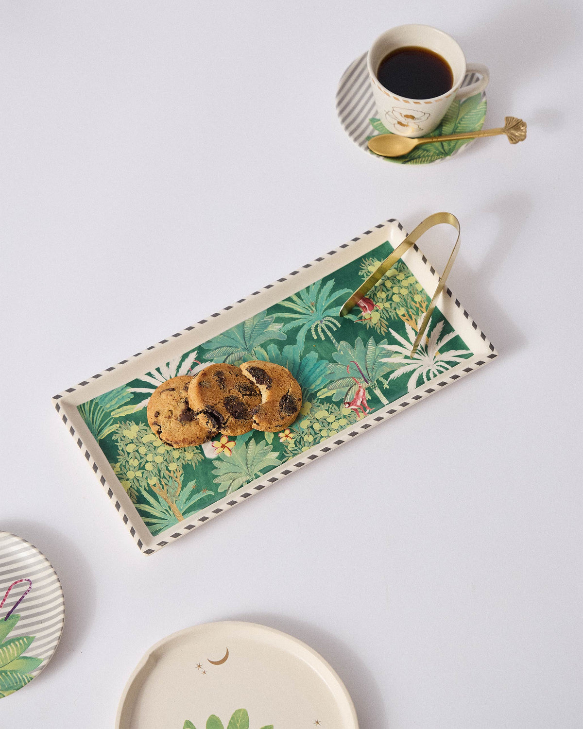 Ceylon Trail Cookie Tray holding cookies beside a cup of coffee.