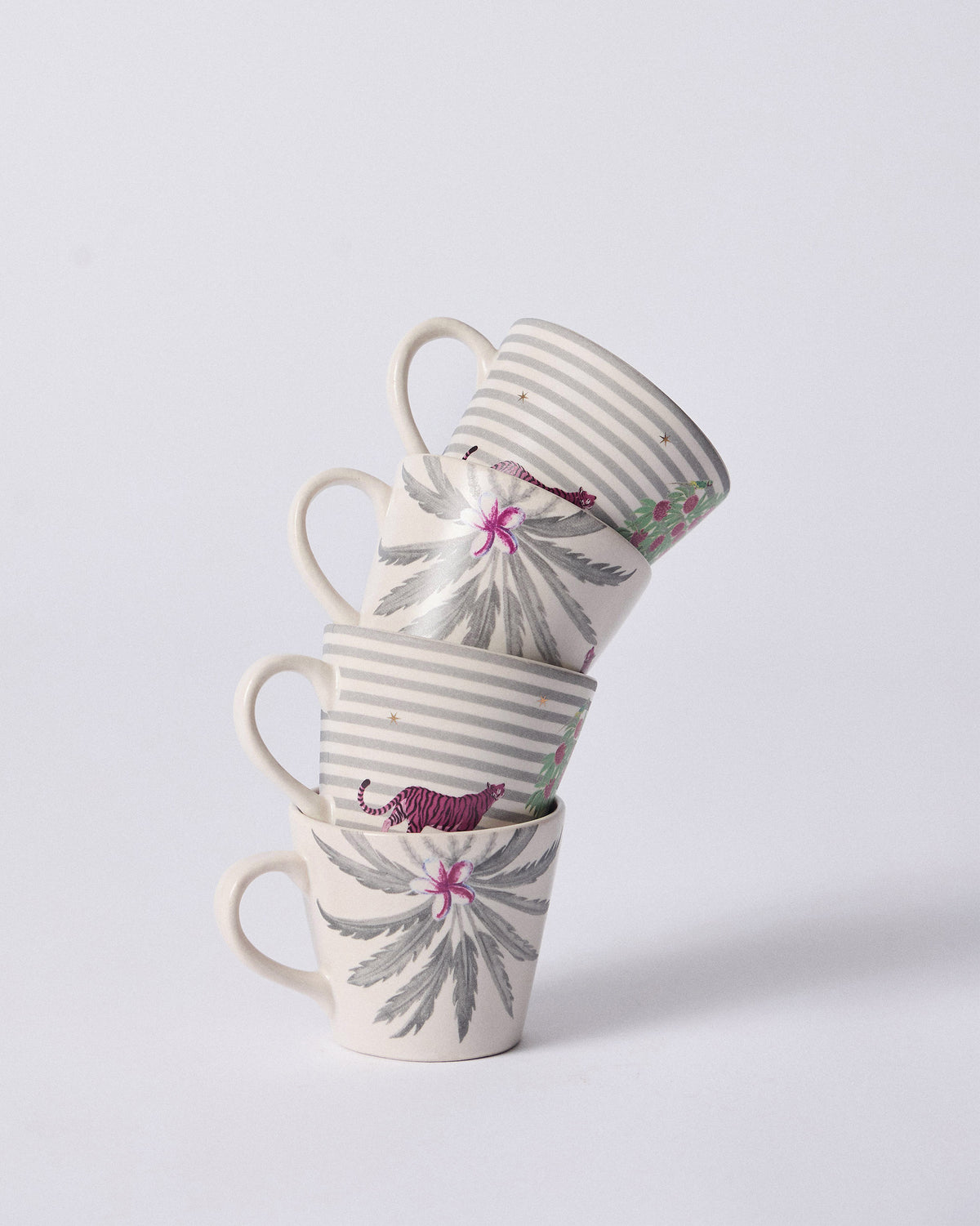 Stack of four Ceylon Trail Espresso Mugs alternating palm and tiger prints.
