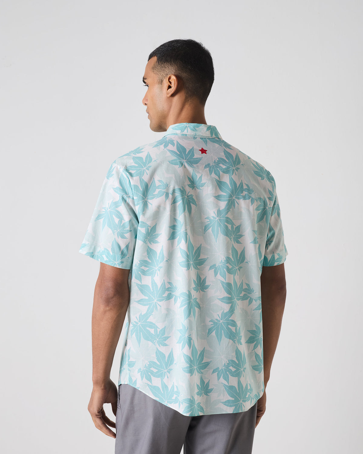 Back of a light blue Mistari shirt with a red star at the yoke.