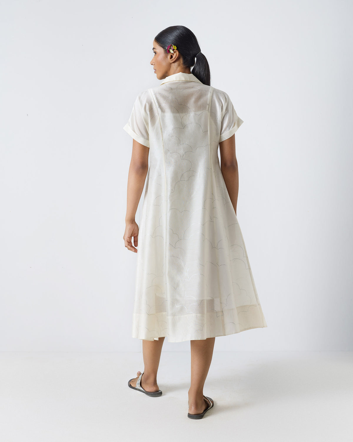Back of an ivory Cadeau Dress with a silver wavy print.
