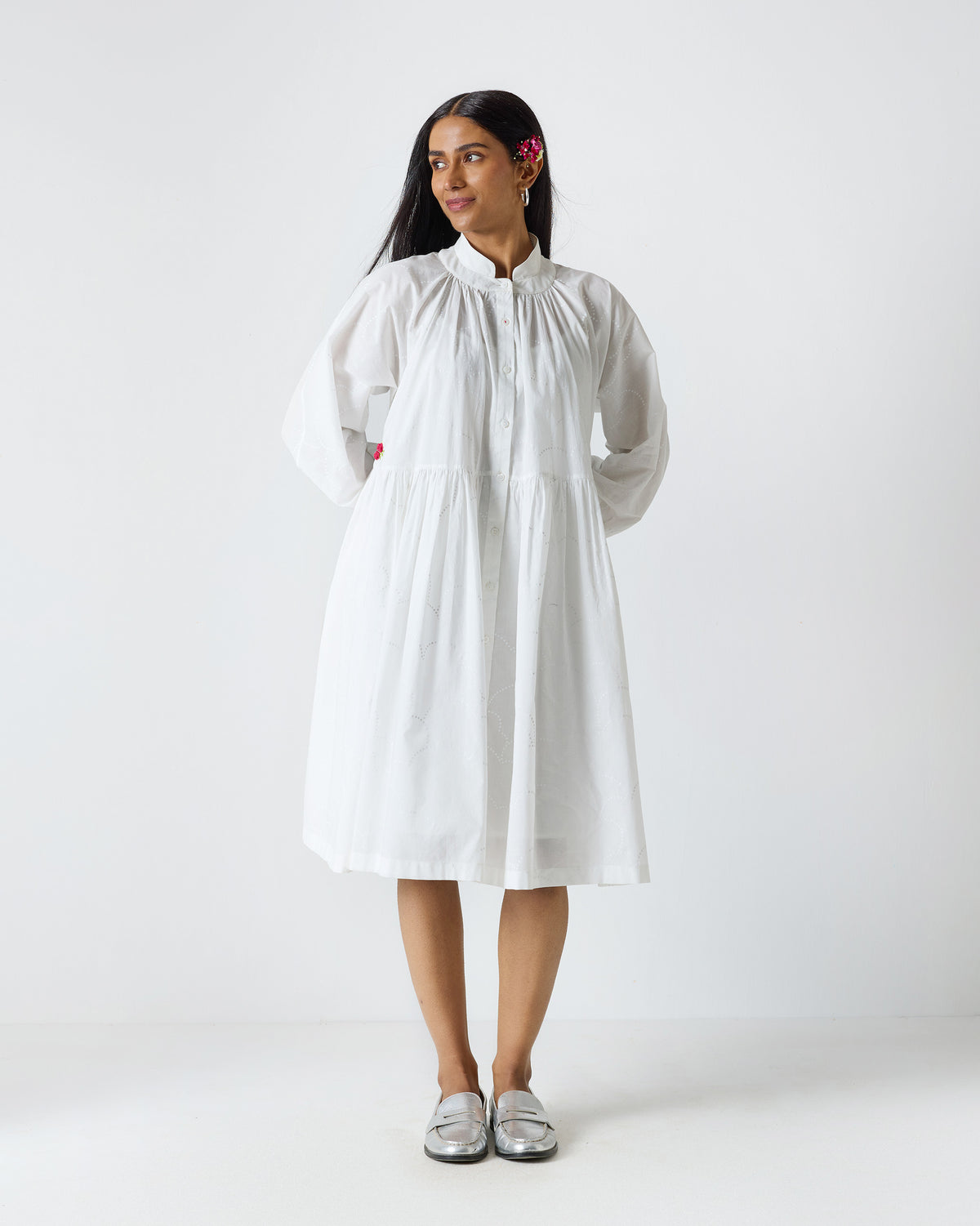 Person wearing a white Miya button-front dress with a mandarin collar.