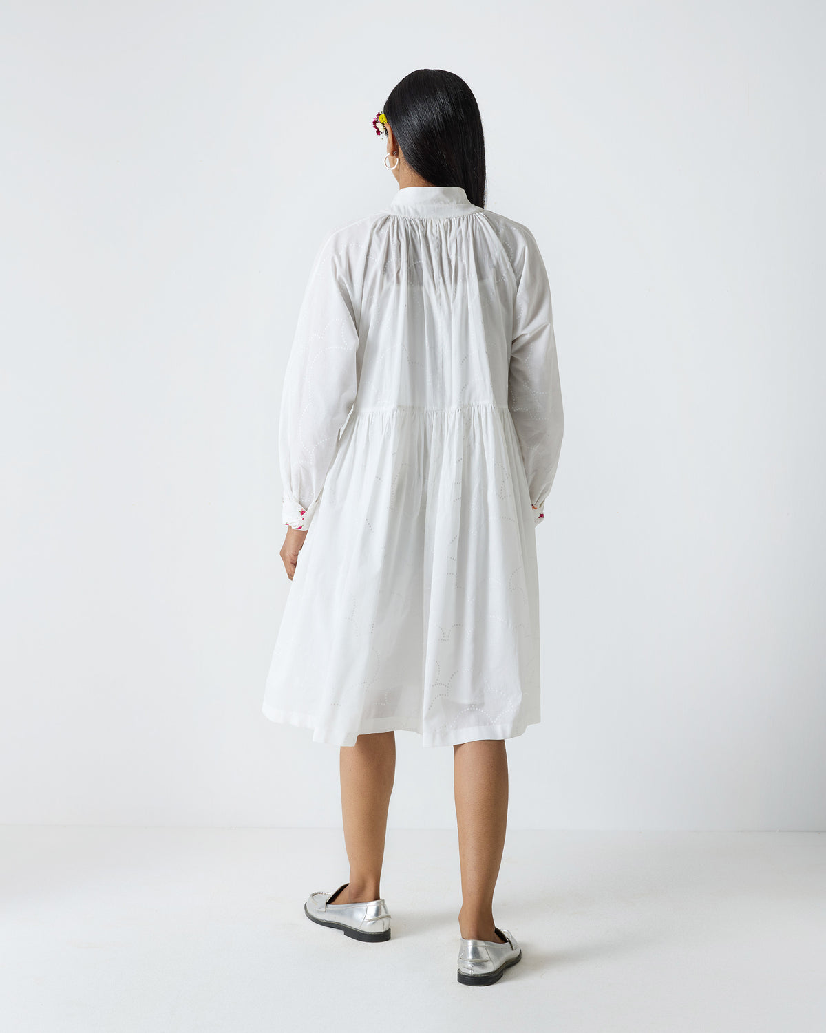 Back of a white Miya button-front dress with a gathered skirt.