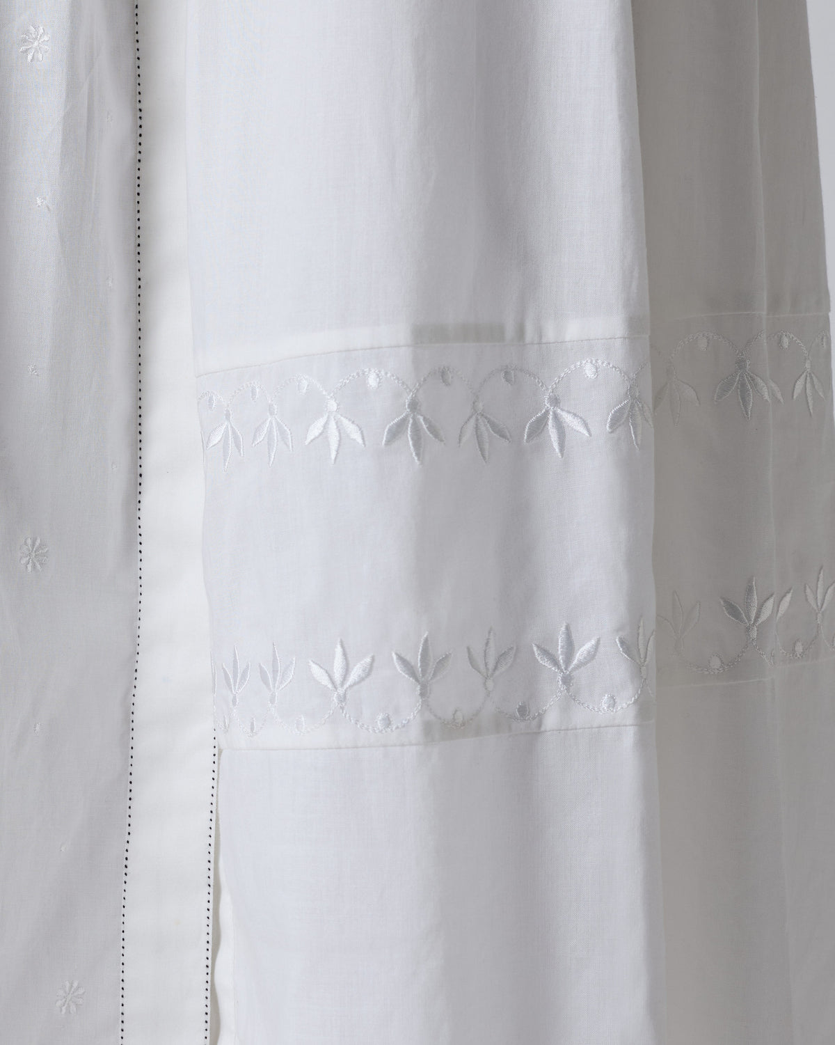 Close-up of white-on-white embroidery on a Rayna dress.
