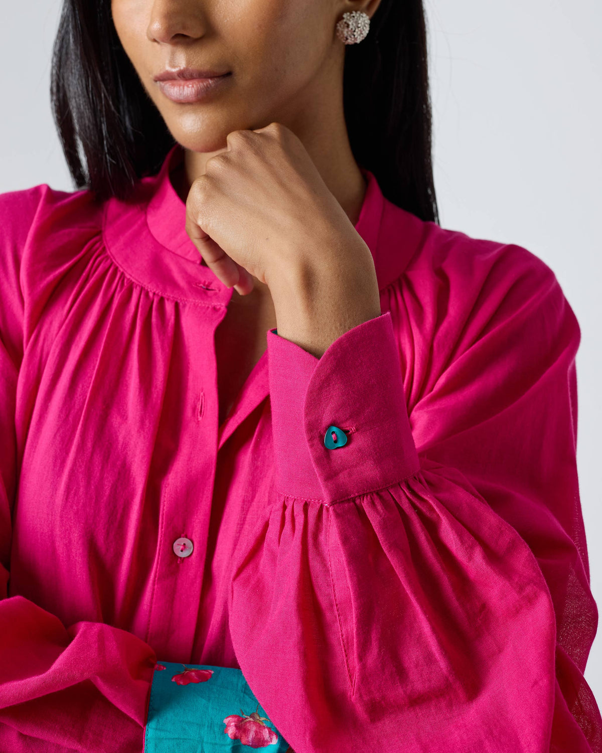 Close-up of fuchsia Miya dress collar, gathered sleeves, and turquoise cuff button.