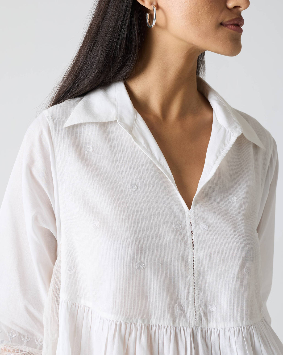 Close-up of a white kurta collar with tonal embroidery.