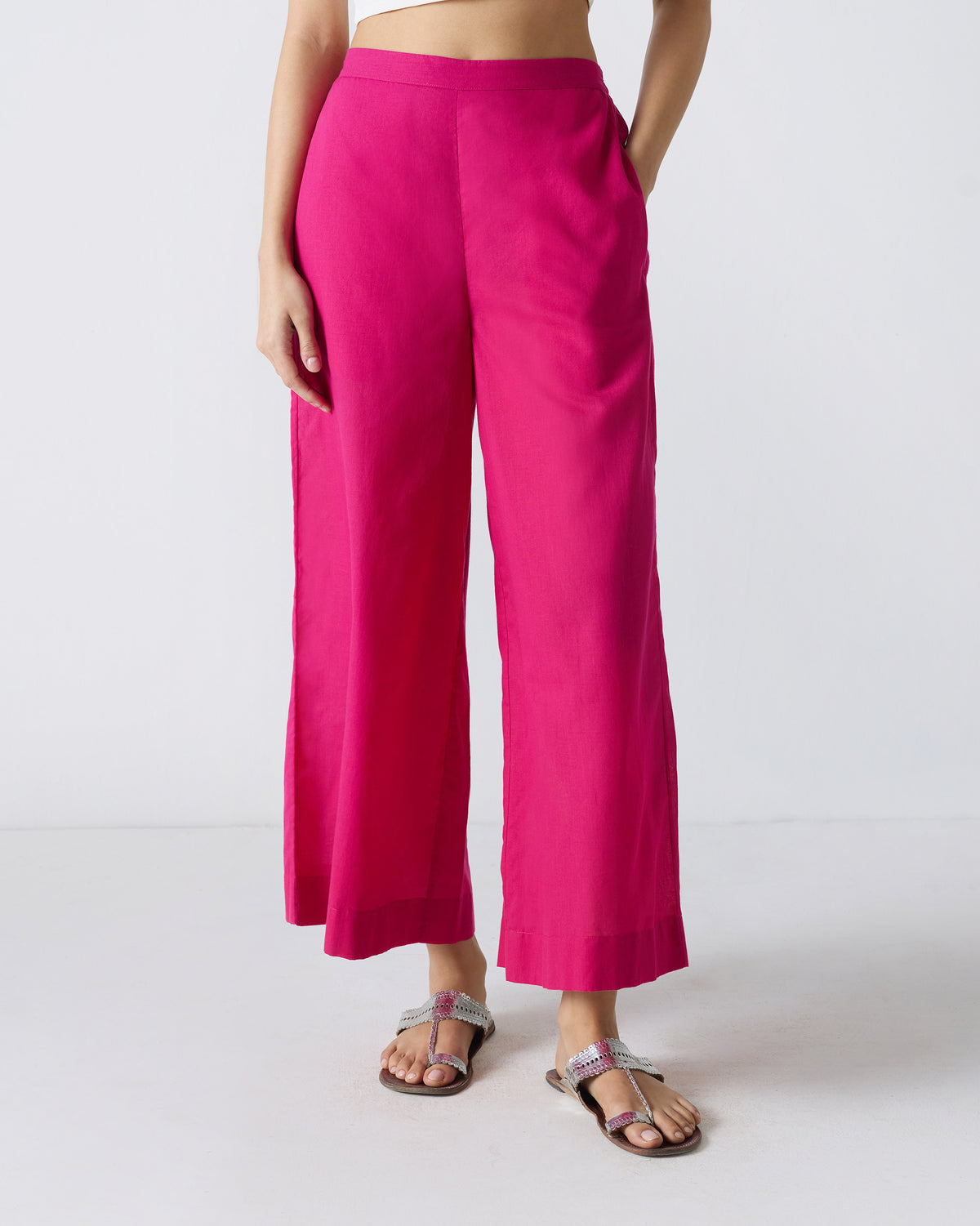 Person wearing fuchsia wide-leg Basic Pyjamas with a hand in the pocket.