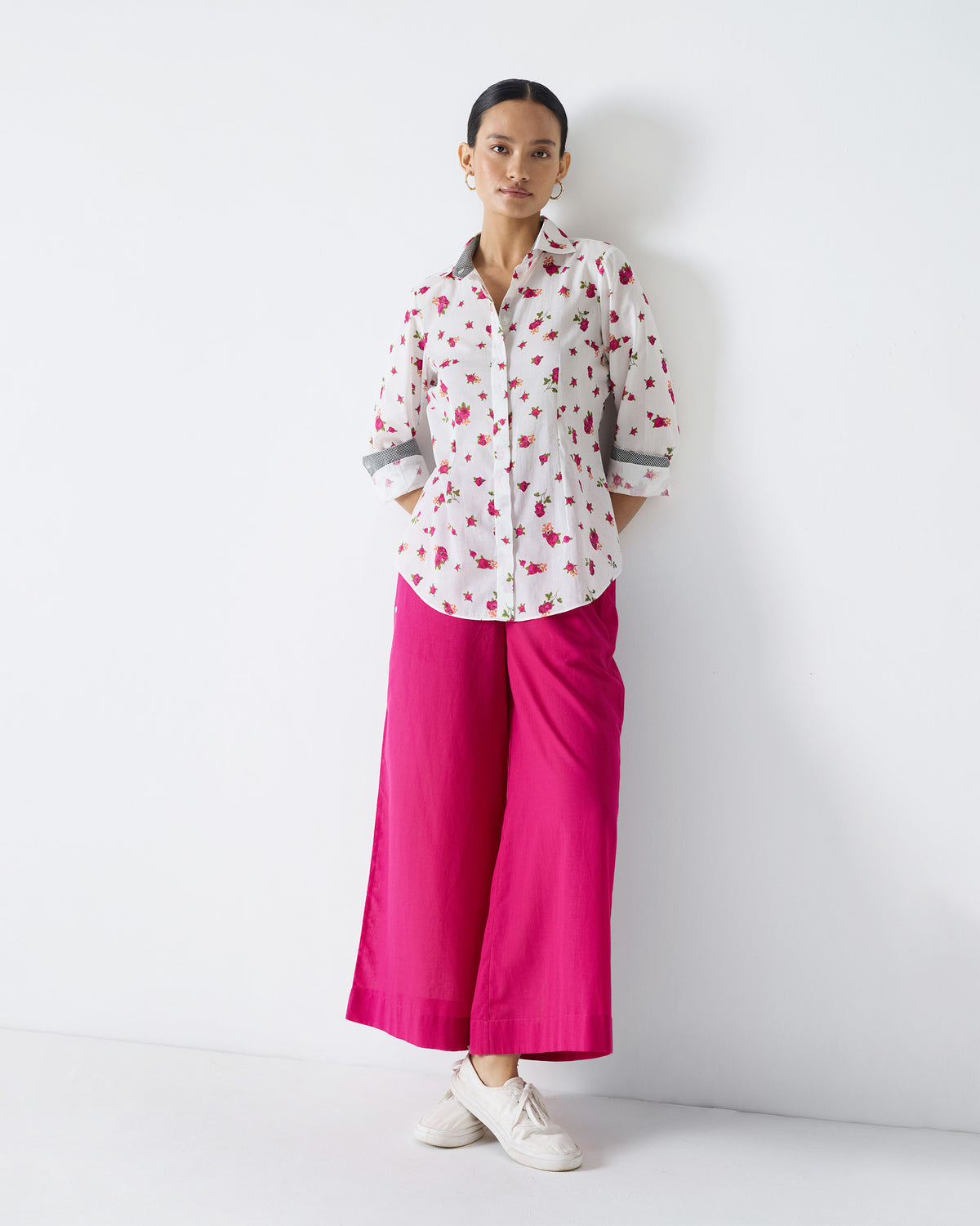 Person wearing fuchsia Basic Pyjamas with a white floral shirt.