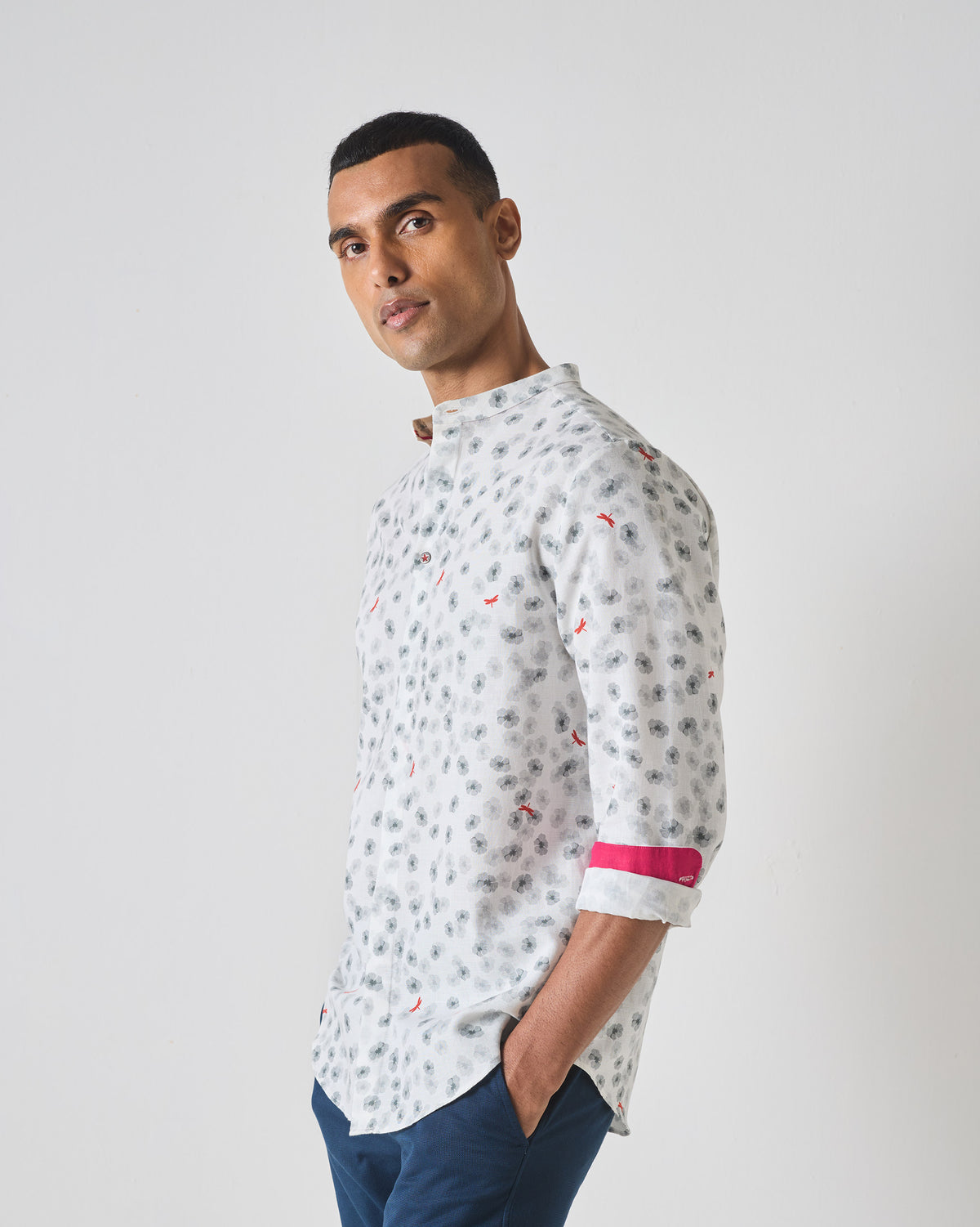 Three-quarter view of a white One Button Shirt with a grey floral print.