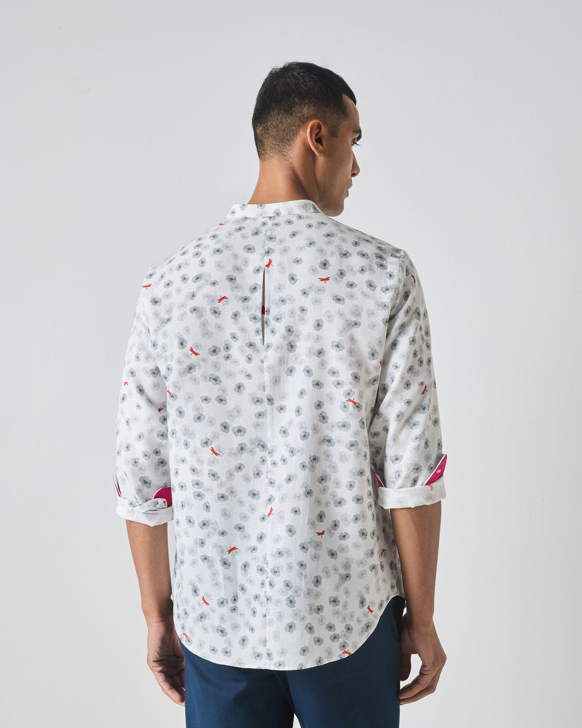 Back of a white One Button Shirt showing a centre back vent and floral print.