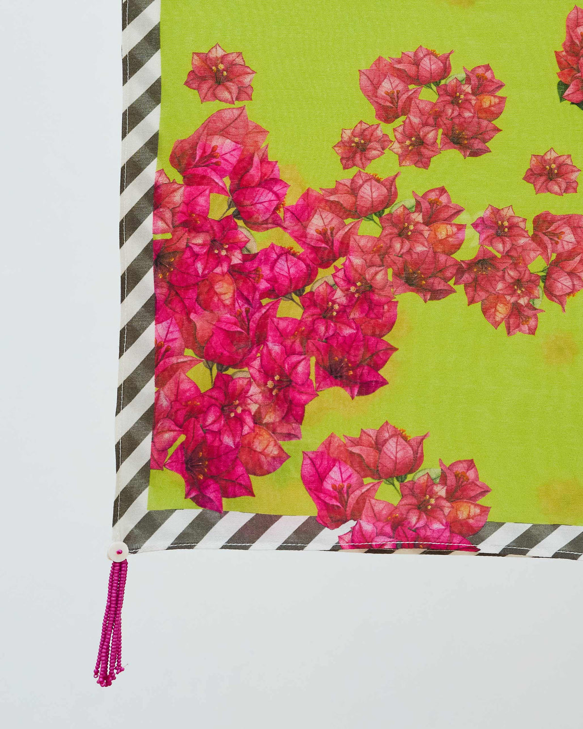 Close-up of the Bougainvillea scarf corner showing pink blooms and a pink tassel.
