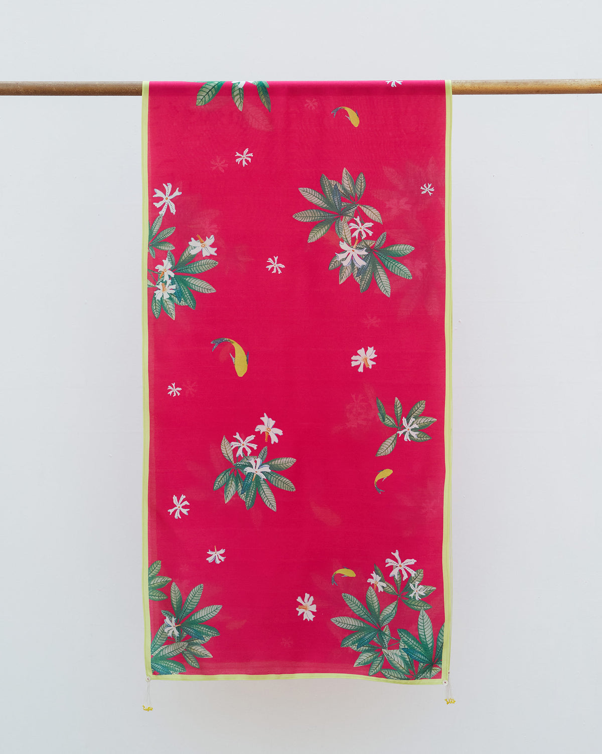 Leaping Fish scarf hung flat, showing white flowers and green leaves on fuchsia.