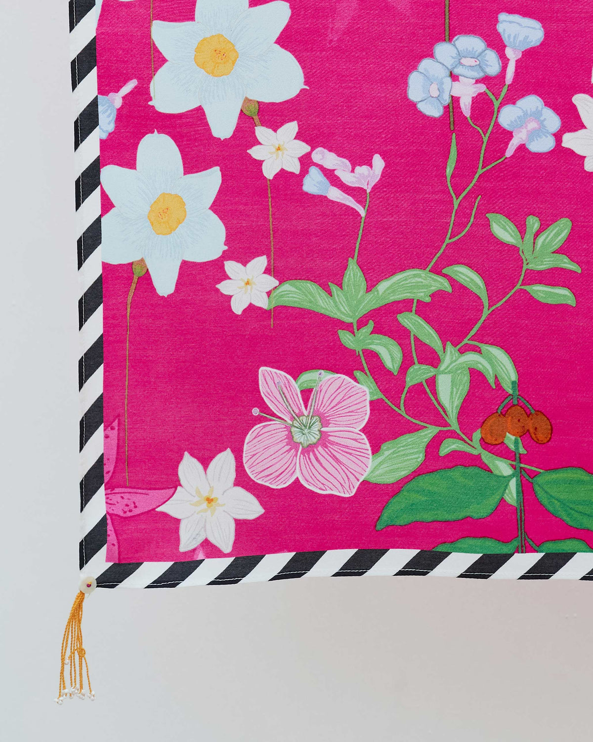 Close-up of Wildflower Scarf corner showing white and pink flowers and a striped border.