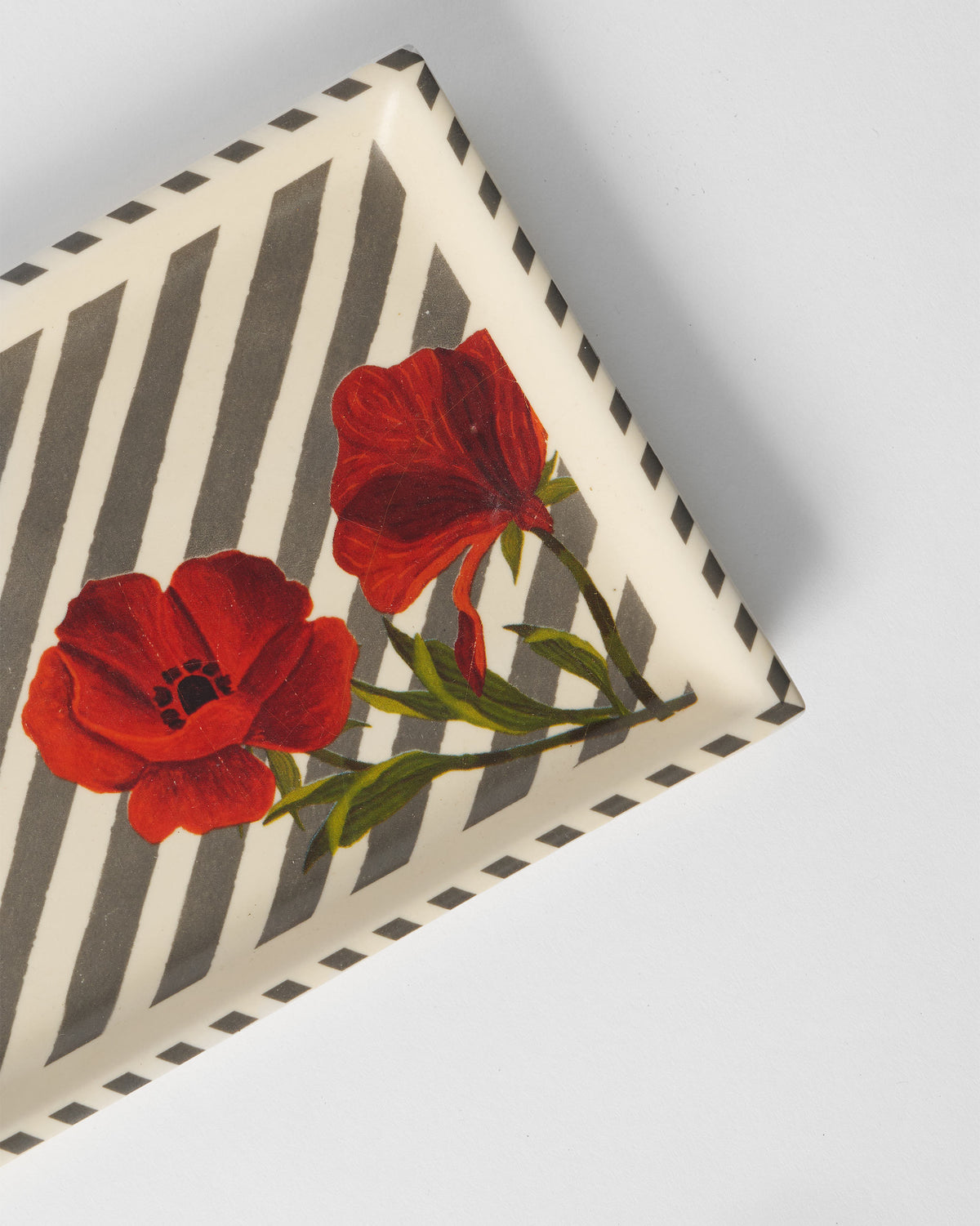 Close-up of red poppies on the grey-striped Striped Poppy cookie tray.