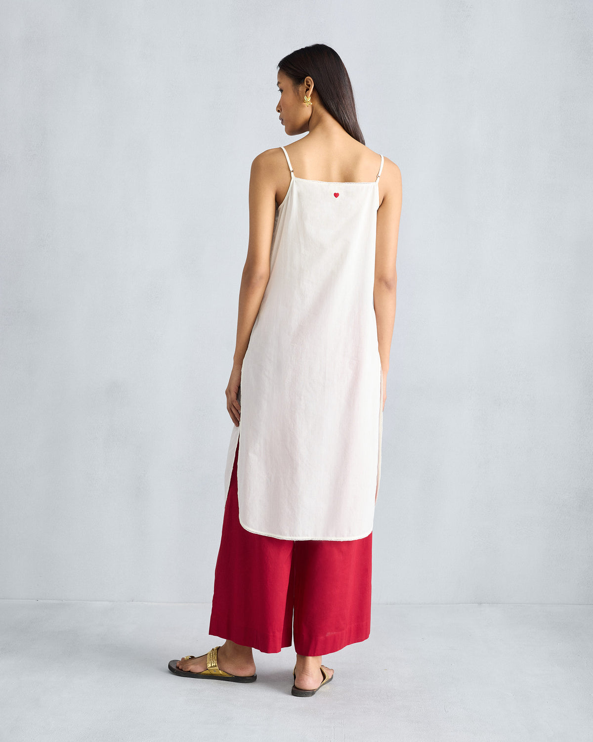 Back of an ivory vintage camisole with a red heart embroidery.
