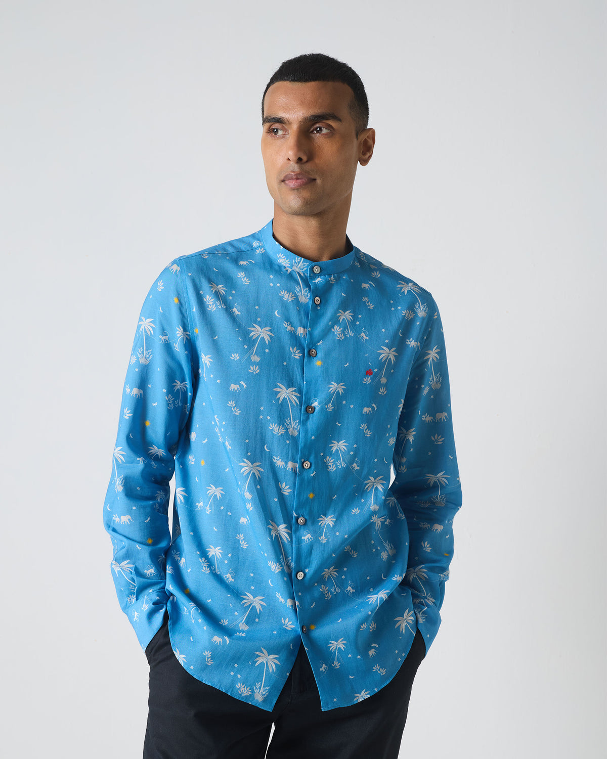 Person wearing a blue Nawab shirt with white palm print.