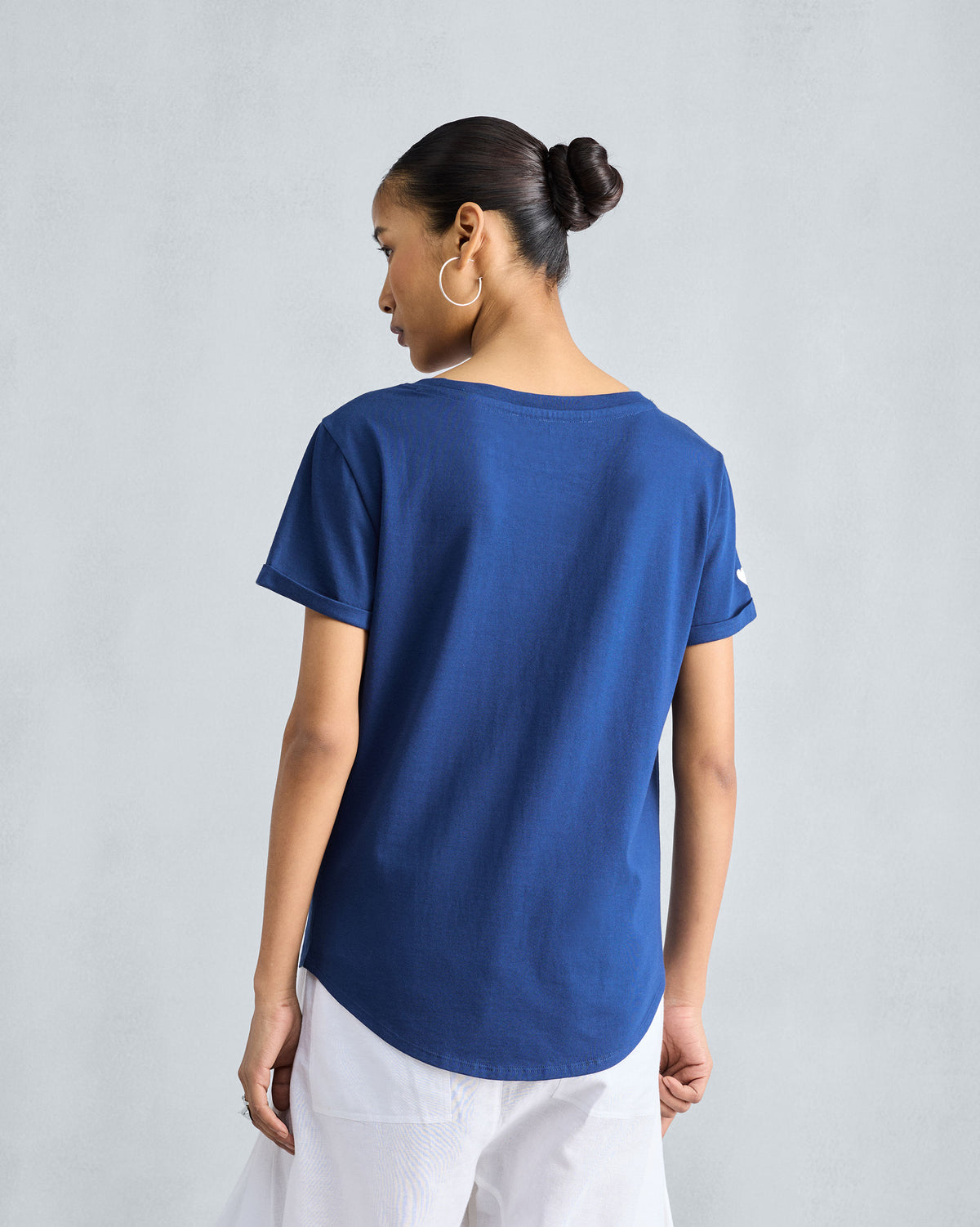 Back of a navy Basic T-Shirt with a curved hem.