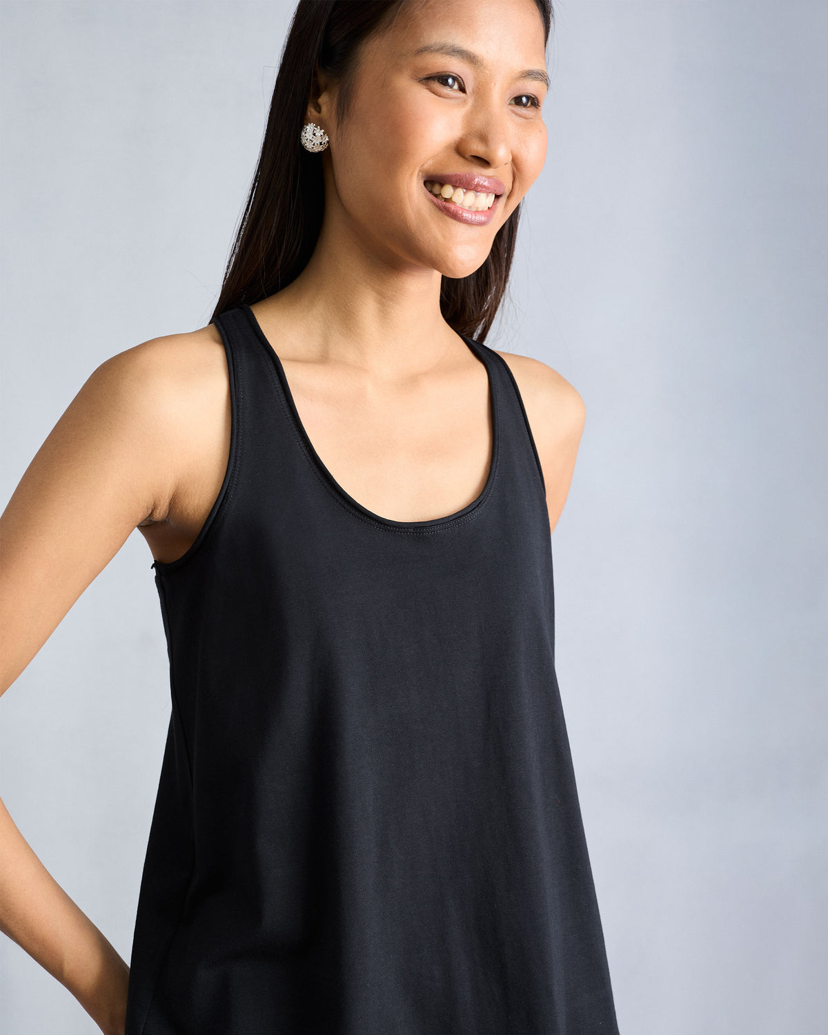 Person wearing a black Ukiyo tank showing the scoop neckline.