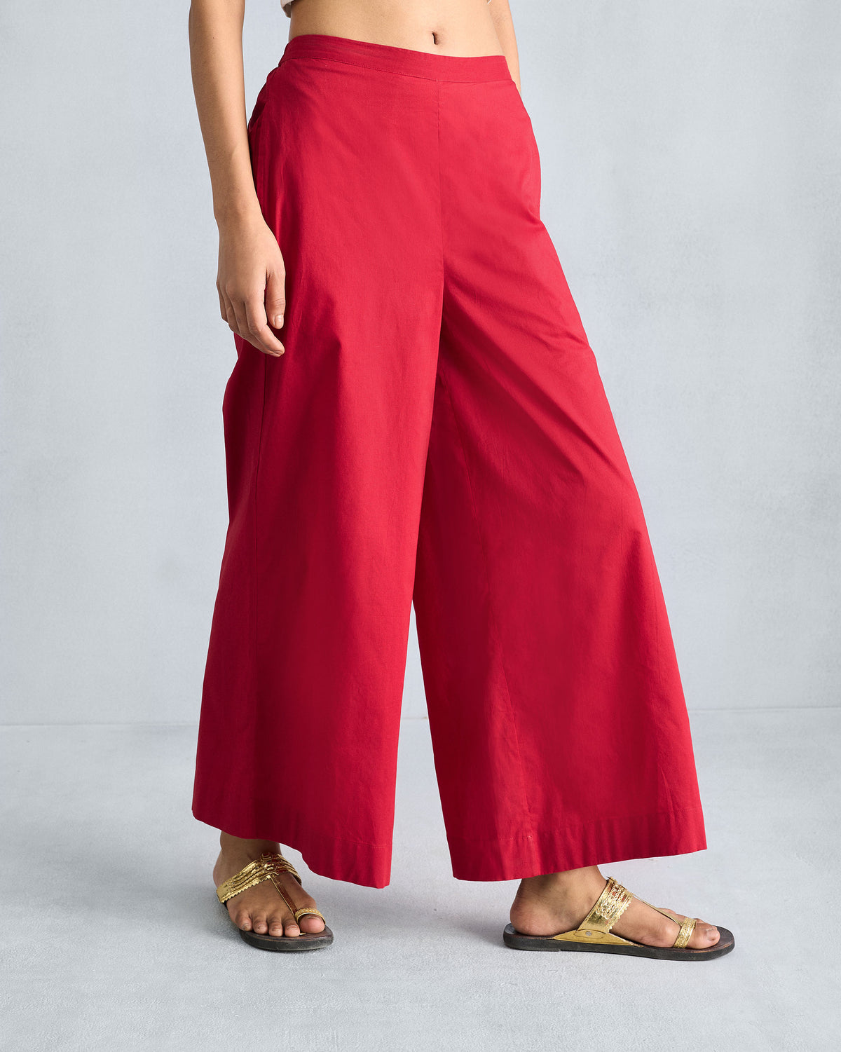 Person wearing red Basic pyjamas showing the wide-leg drape.