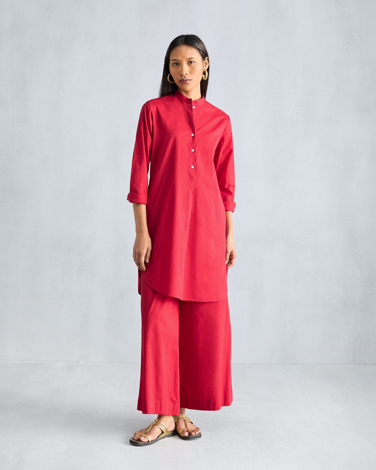 Person wearing red Basic pyjamas with a matching red kurta.