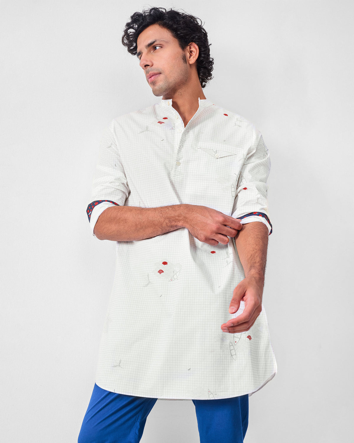 Person wearing a white Fort kurta with grey boat print and red accents.