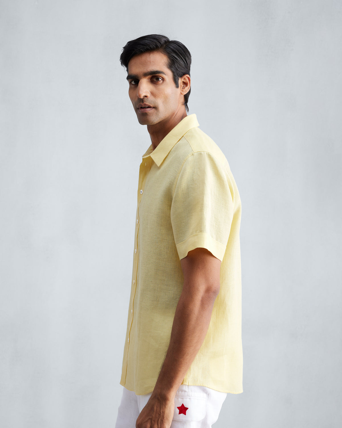 Side view of a lemon half-sleeve shirt worn by a person.