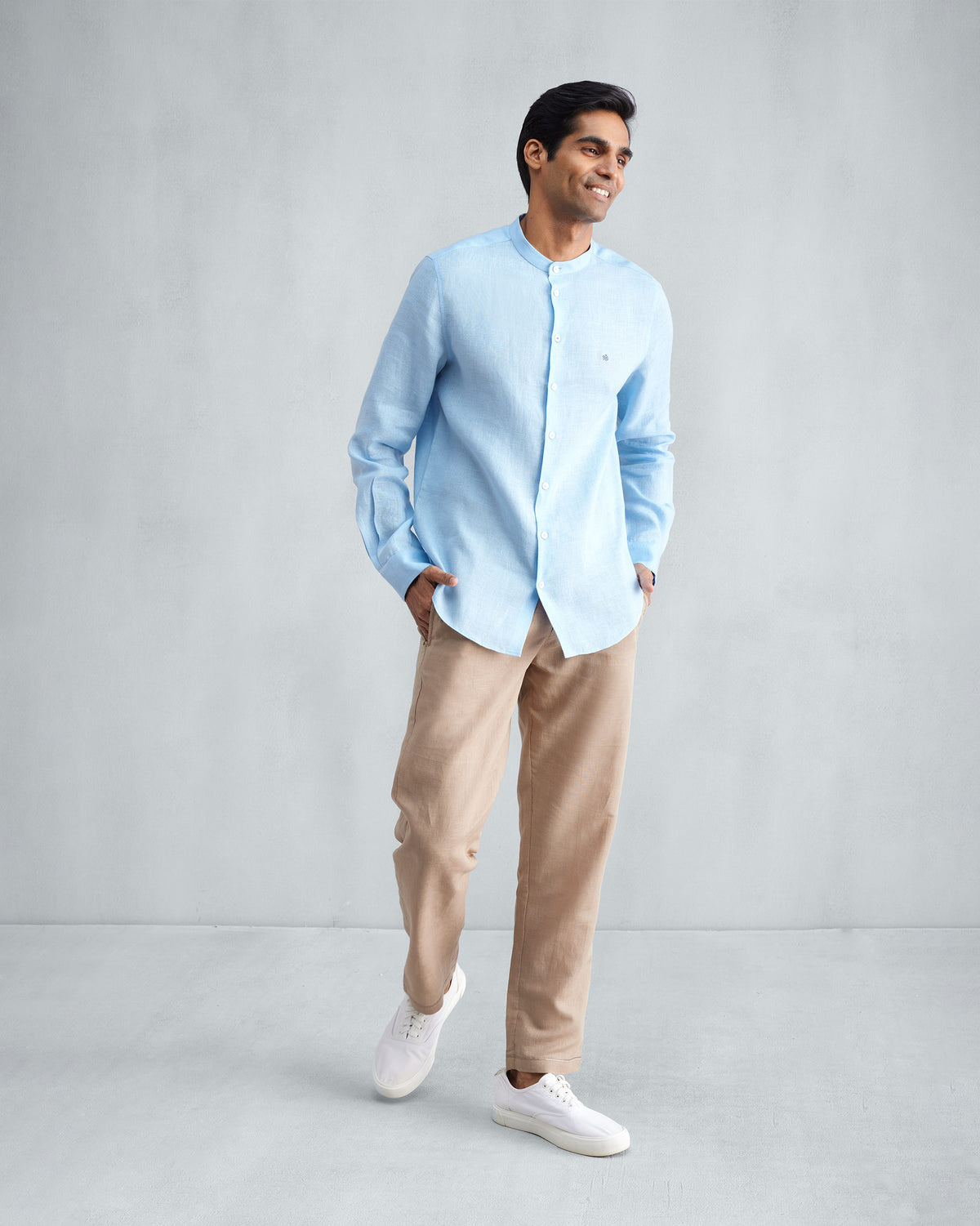 Person wearing a light blue Nehru collar Nawab shirt untucked.