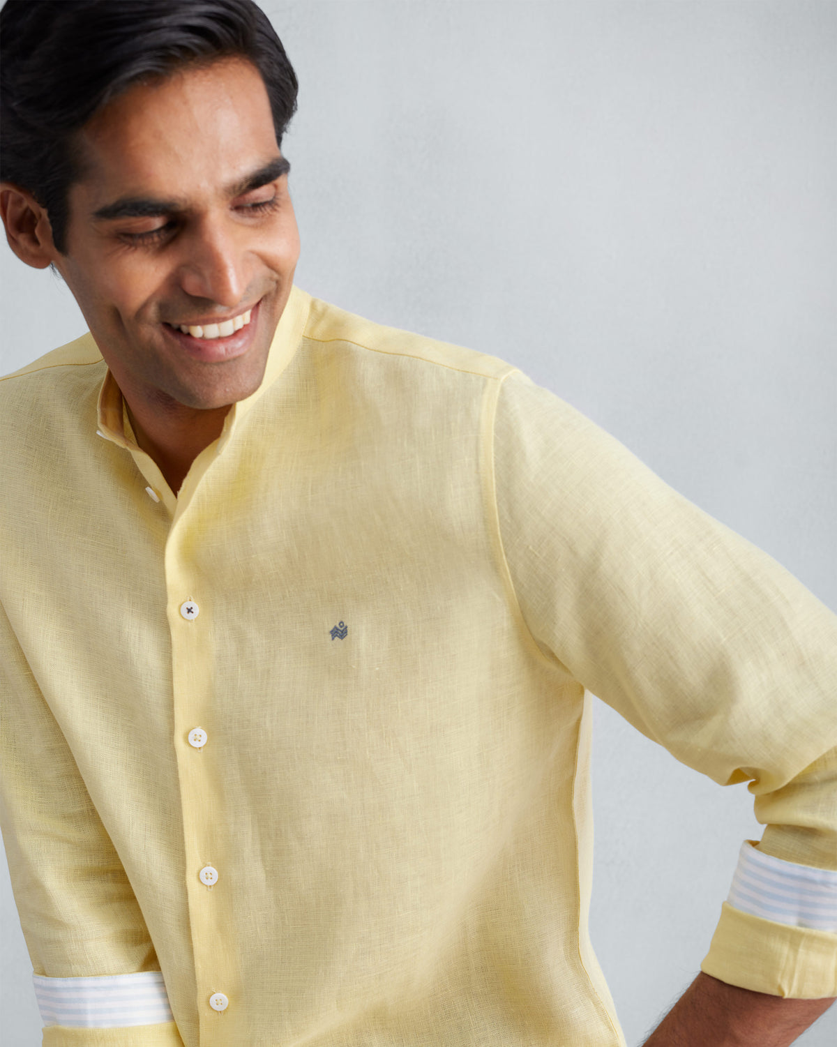 Lemon Nawab shirt with striped cuff trim worn at a three-quarter angle.