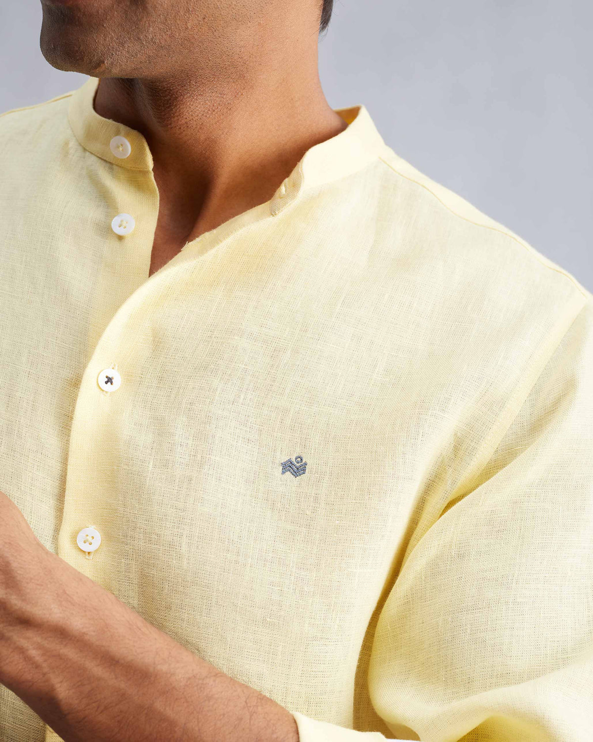 Close-up of a lemon Nawab shirt showing the Nehru collar and chest logomark.