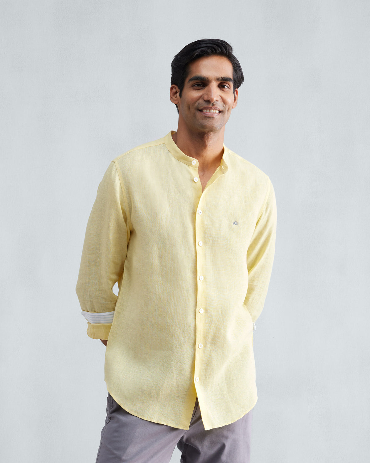 Person wearing a lemon Nawab shirt with a Nehru collar and rolled sleeves.