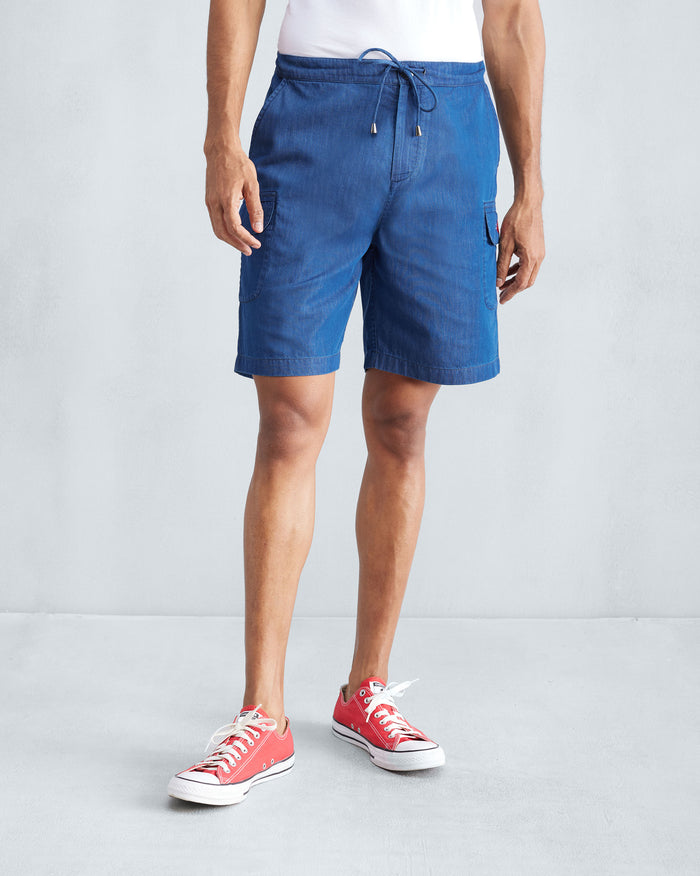 Person wearing denim Classic Shorts with a drawstring waist.
