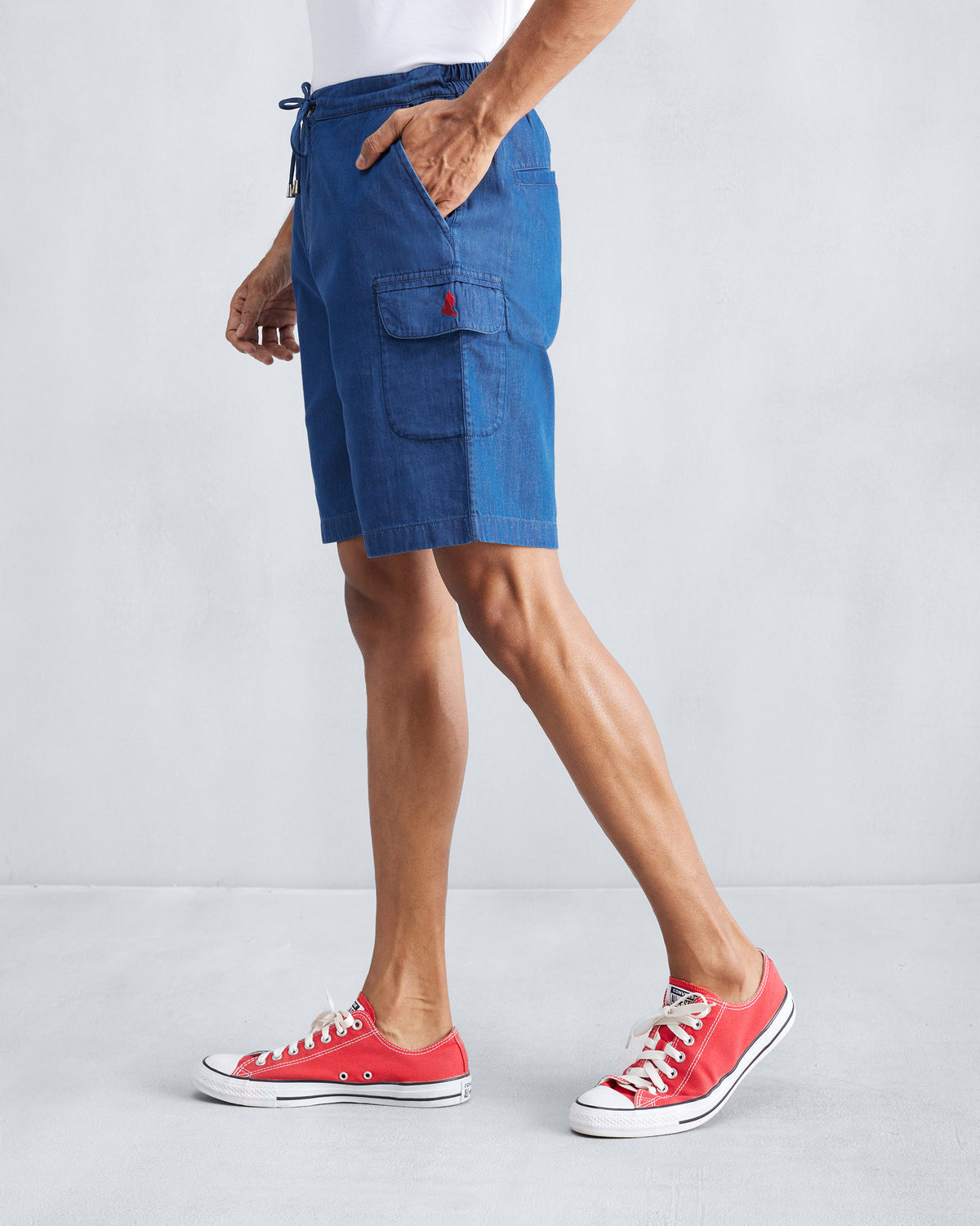 Side view of denim Classic Shorts showing the cargo pocket.