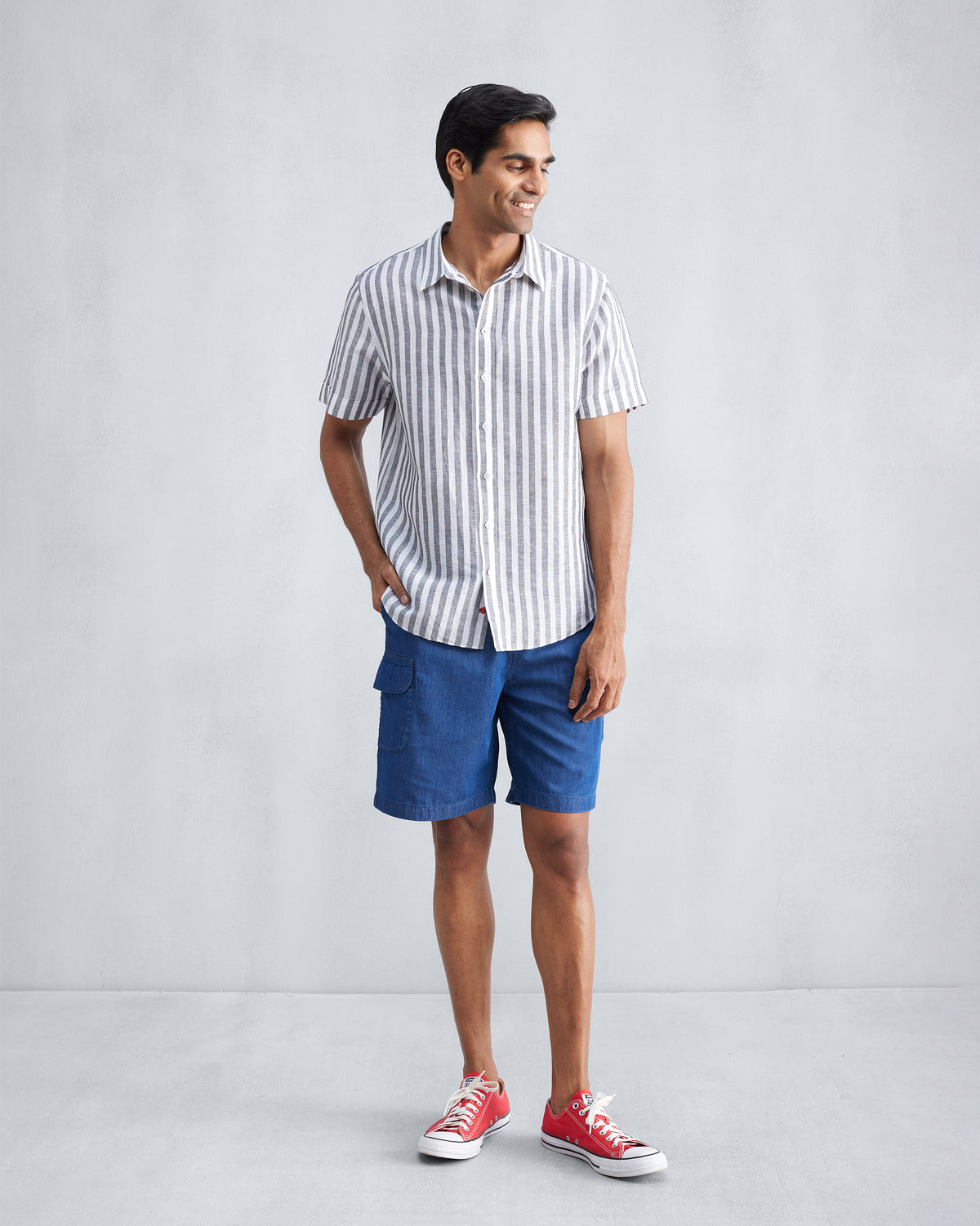 Person wearing blue denim Classic Shorts with a cargo pocket.