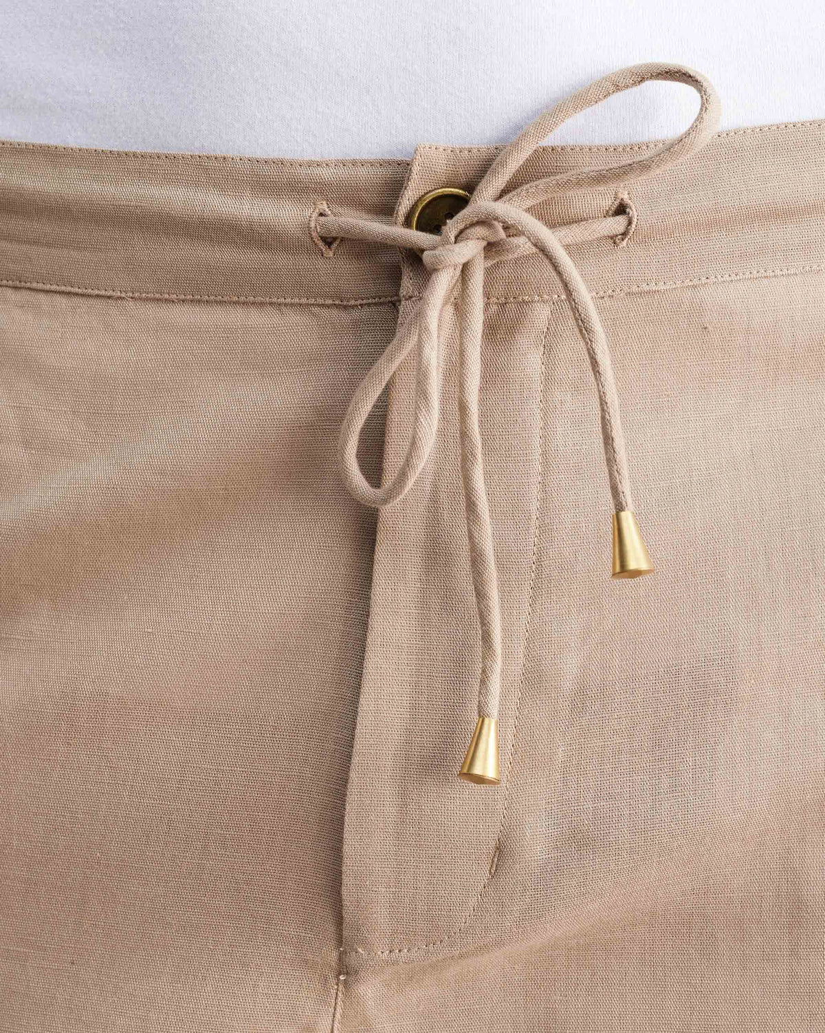 Close-up of the drawstring waistband on beige Classic Shorts.