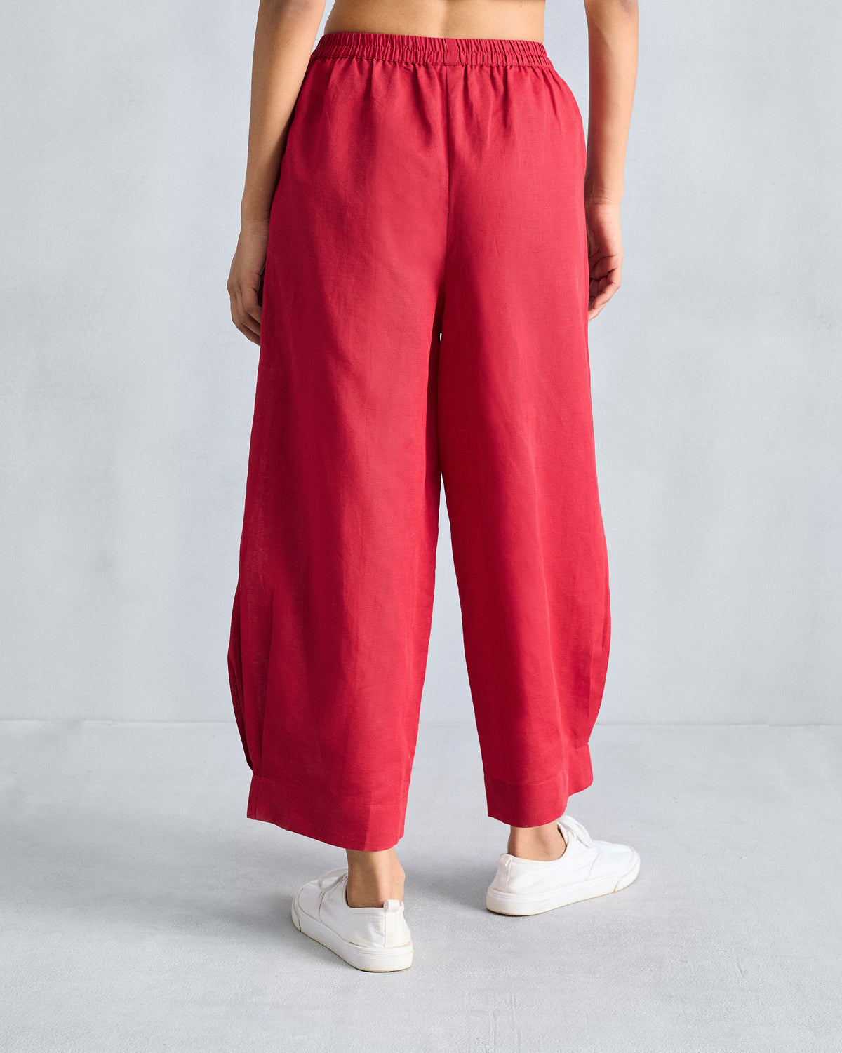 Back of red cropped wide-leg pants with an elastic waist.