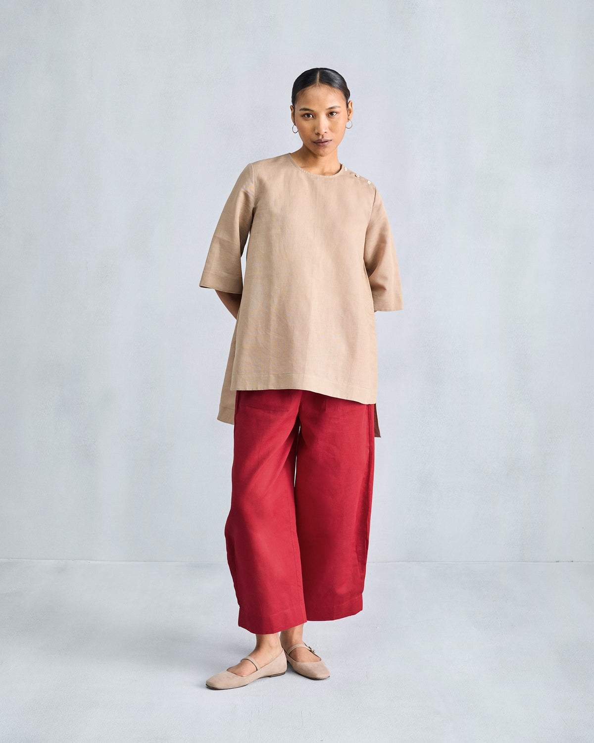 Person wearing red wide-leg pants with front patch pockets.
