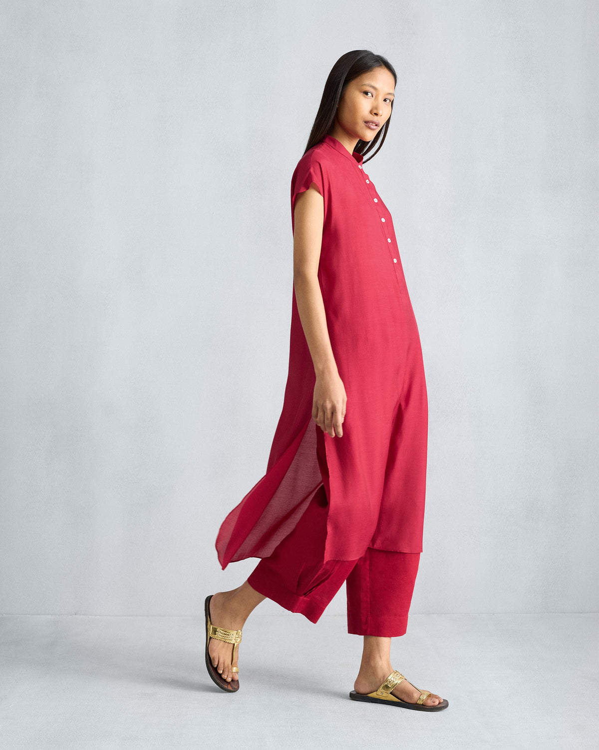 Side view of a red short sleeve kurta worn by a person.