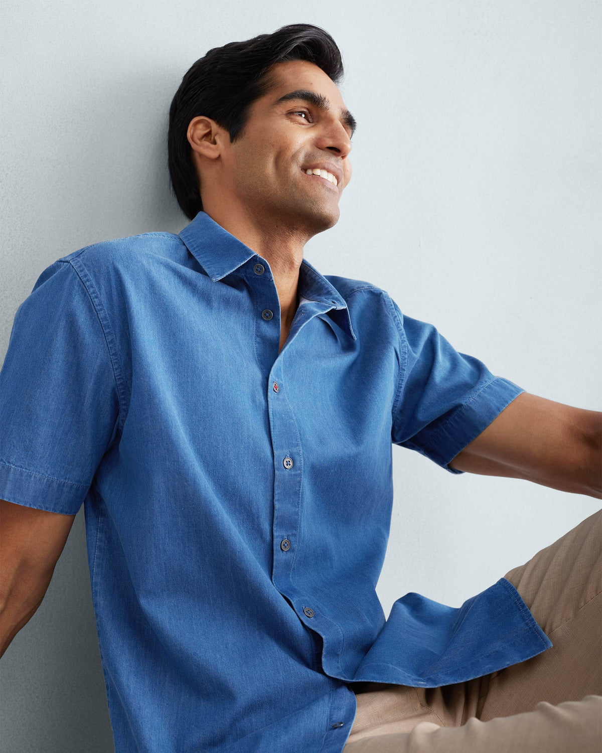 Denim half sleeve shirt worn seated, showing the front drape.