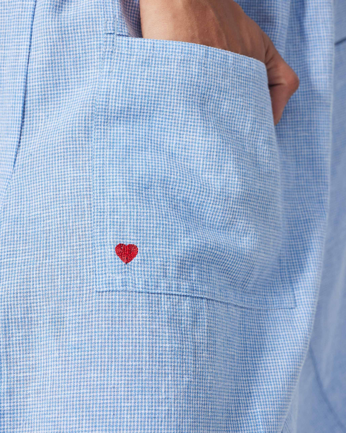 Close-up of a Sakura set trouser pocket with a red embroidered heart.